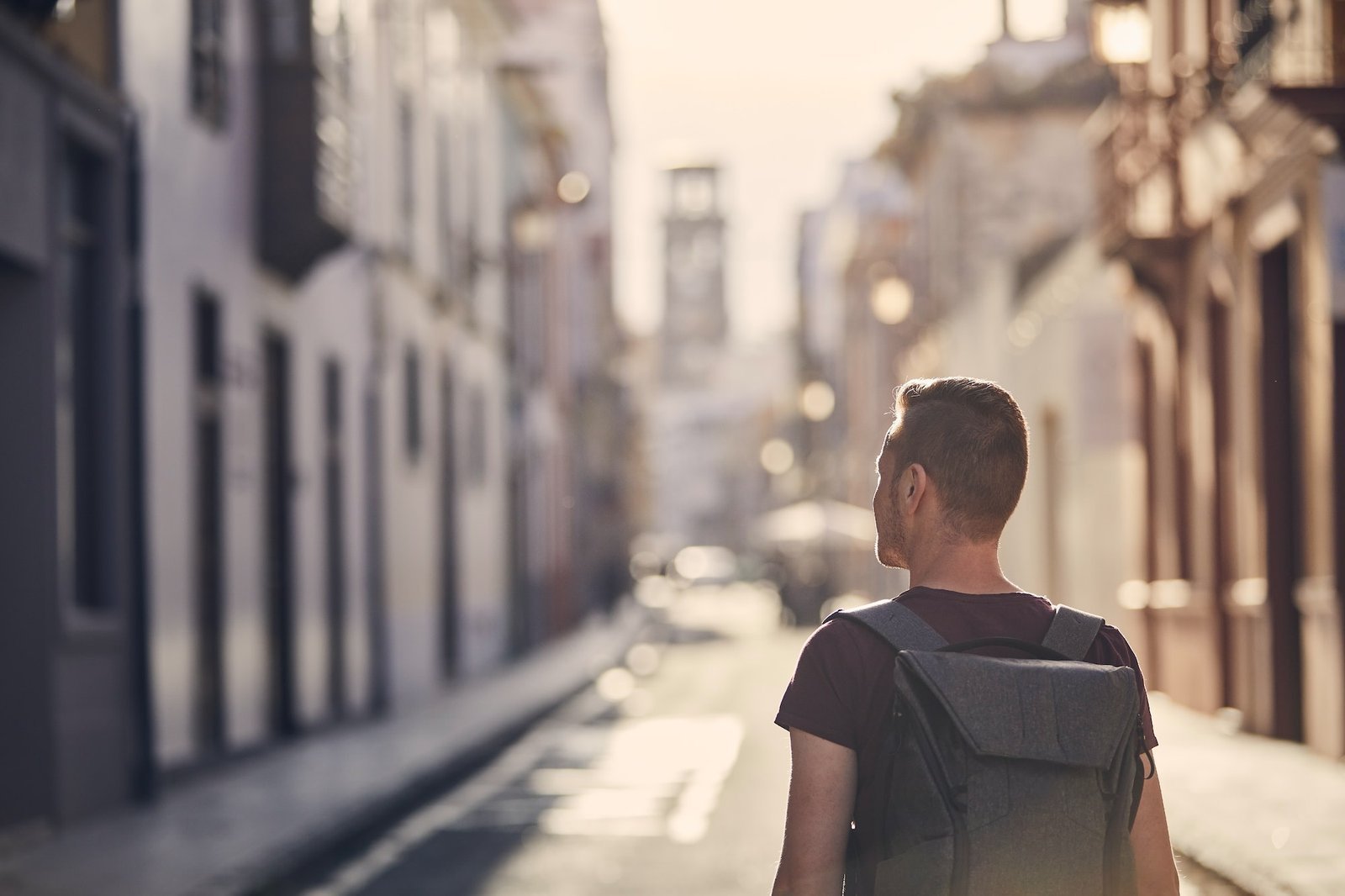 Traveler with a backpack on the street of an old town